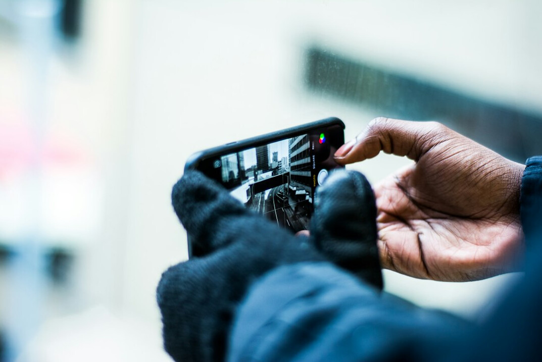 Camera operator filming with a professional video camera